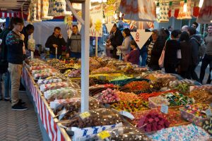 Busy local market stall selling sweets